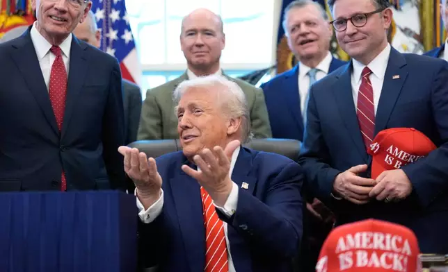 President Donald Trump speaks to reporters after signing a spending bill that ends a partial shutdown of the federal government in the Oval Office of the White House, Tuesday, Feb. 3, 2026, in Washington. (AP Photo/Alex Brandon)