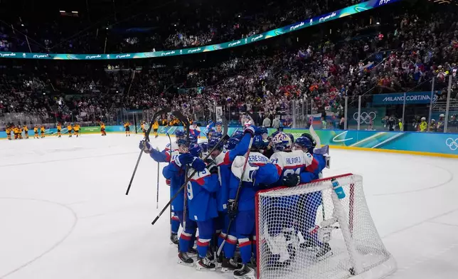 Slovakia players celebrate there victory after a men's ice hockey quarterfinal game between Slovakia and Germany at the 2026 Winter Olympics, in Milan, Italy, Wednesday, Feb. 18, 2026. (AP Photo/Petr David Josek)