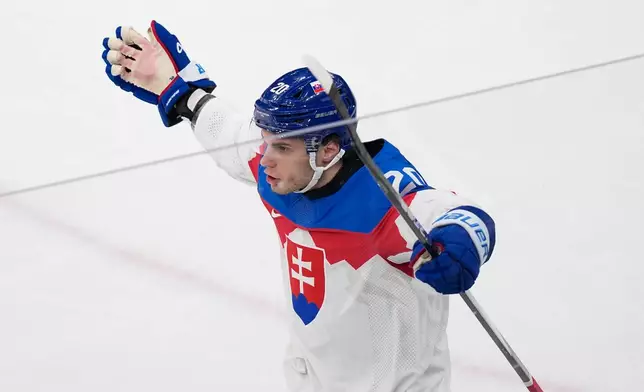 Slovakia's Juraj Slafkovsky celebrates after scoring his side's opening goal during a preliminary round match of men's ice hockey between Sweden and Slovakia at the 2026 Winter Olympics, in Milan, Italy, Saturday, Feb. 14, 2026. (AP Photo/Petr David Josek)
