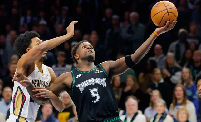 Minnesota Timberwolves guard Anthony Edwards (5) goes to the basket against New Orleans Pelicans forward Trey Murphy III, left, in the first quarter of an NBA basketball game Friday, Feb. 6, 2026, in Minneapolis. (AP Photo/Bruce Kluckhohn)