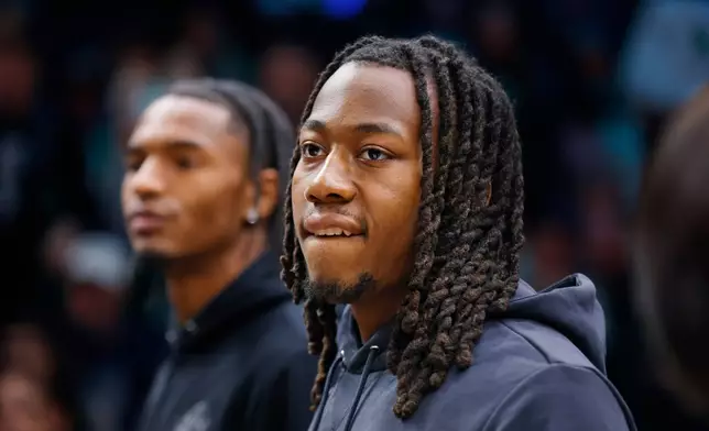 Minnesota Timberwolves guards Ayo Dosunmu, front, and Julian Phillips, rear, look around during a timeout after the first quarter of an NBA basketball game with the New Orleans Pelicans Friday, Feb. 6, 2026, in Minneapolis. The two were traded to Minnesota the day before. (AP Photo/Bruce Kluckhohn)