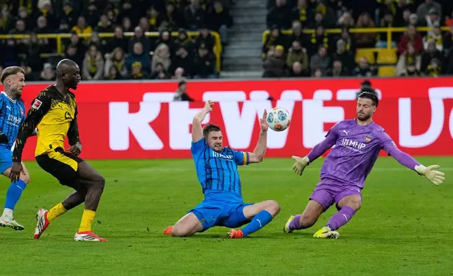 Dortmund's Serhou Guirassy misses to score against Heidenheim's goalkeeper Diant Ramaj during the German Bundesliga soccer match between Borussia Dortmund and FC Heidenheim in Dortmund, Germany, Sunday, Feb. 1, 2026. (AP Photo/Martin Meissner)