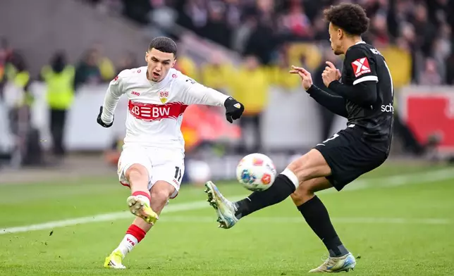 Freiburg's Derry Scherhant, right, and Stuttgart's Bilal El Khannouss, left, challenge for the ball during the German Bundesliga soccer match between VfB Stuttgart and SC Freiburg in Stuttgart, Germany, Sunday, Feb. 1, 2026. (Harry Langer/dpa via AP)