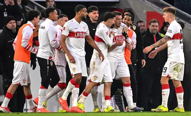 Stuttgart's scorer Ermedin Demirovic, front second right, and his teammates celebrate the opening goal during the German Bundesliga soccer match between VfB Stuttgart and SC Freiburg in Stuttgart, Germany, Sunday, Feb. 1, 2026. (Harry Langer/dpa via AP)