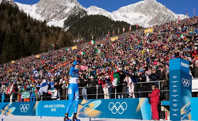 Lisa Vittozzi, of Italy, crosses the finish line to win gold during the women's 10-kilometer pursuit biathlon race at the 2026 Winter Olympics in Anterselva, Italy, Sunday, Feb. 15, 2026. (AP Photo/David J. Phillip)