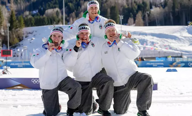 Davide Graz, Elia Barp, Martino Carollo and Federico Pellegrino, of Italy, pose after winning the bronze medal in the cross country skiing men's 4 x 7.5km relay at the 2026 Winter Olympics, in Tesero, Italy, Sunday, Feb. 15, 2026. (AP Photo/Kirsty Wigglesworth)