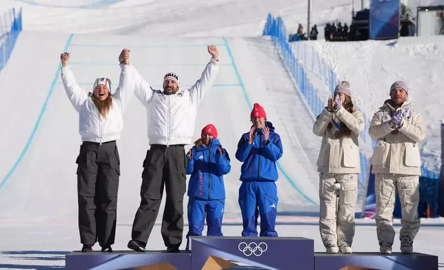 From left, silver medalists Italy's Michela Moioli and Lorenzo Sommariva, gold medalists Britain's Charlotte Bankes and Huw Nightingale, and bronze medalists France's Lea Casta and Loan Bozzolo celebrate after the mixed team snowboard cross finals at the 2026 Winter Olympics, in Livigno, Italy, Sunday, Feb. 15, 2026. (AP Photo/Lindsey Wasson)