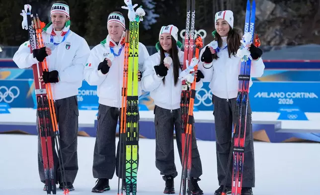 Italy's Lisa Vittozzi, Dorothea Wierer, Lukas Hofer and Tommaso Giacomel pose with the silver medal for the 4X6-kilometer mixed relay biathlon race at the 2026 Winter Olympics in Anterselva, Italy, Sunday, Feb. 8, 2026. (AP Photo/Andrew Medichini)