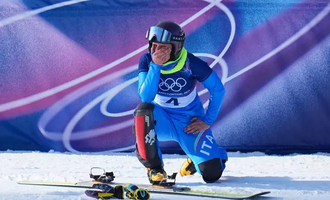 Italy's Lucia Dalmasso celebrates winning the bronze medal against Italy's Elisa Caffont during the women's snowboarding parallel giant slalom finals at the 2026 Winter Olympics, in Livigno, Italy, Sunday, Feb. 8, 2026. (AP Photo/Gregory Bull)
