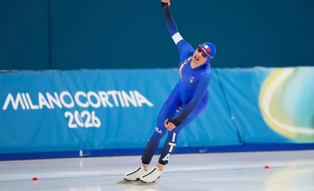 Riccardo Lorello of Italy celebrates after competing in the men's 5,000 meters speedskating race at the 2026 Winter Olympics, in Milan, Italy, Sunday, Feb. 8, 2026. (AP Photo/Ben Curtis)