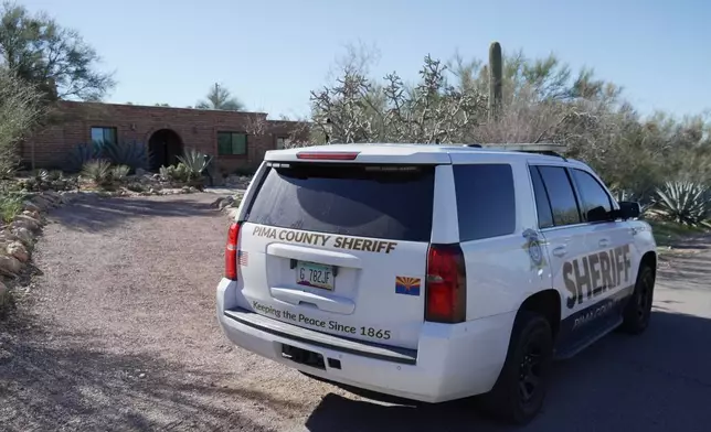 A Pima county sheriff's vehicle is parked out front of Nancy Guthrie’s home on Sunday, Feb. 8, 2026 in Tucson, Ariz. (AP Photo/Ty ONeil)