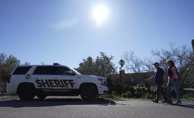 A Pima county sheriff's vehicle is parked out front of Nancy Guthrie’s home on Sunday, Feb. 8, 2026 in Tucson, Ariz. (AP Photo/Ty ONeil)