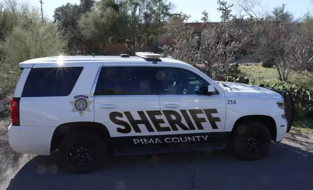 A Pima county sheriff's vehicle is parked out front of Nancy Guthrie’s home on Sunday, Feb. 8, 2026 in Tucson, Ariz. (AP Photo/Ty ONeil)