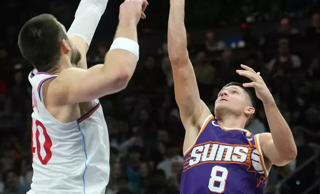 Phoenix Suns guard Grayson Allen (8) shoots over Los Angeles Clippers center Ivica Zubac, right, during the first half of an NBA basketball game Sunday, Feb. 1, 2026, in Phoenix. (AP Photo/Ross D. Franklin)
