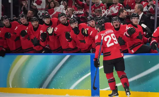 Canada's Nathan MacKinnon (29) is congratulated after scoring a goal against Czechia during the second period of a men's ice hockey quarterfinal game at the 2026 Winter Olympics, in Milan, Italy, Wednesday, Feb. 18, 2026. (AP Photo/Carolyn Kaster)