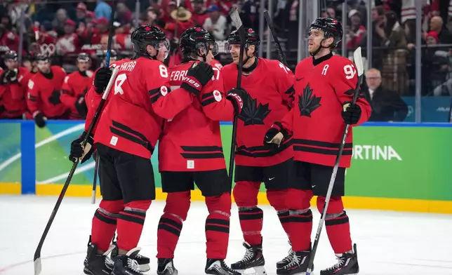 Team Canada players celebrate after a goal by Nathan MacKinnon during the second period of a men's ice hockey quarterfinal game against Czechia at the 2026 Winter Olympics, in Milan, Italy, Wednesday, Feb. 18, 2026. (AP Photo/Carolyn Kaster)