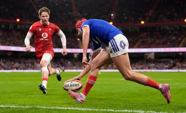 France's Louis Bielle-Biarrey scores a try during the Six Nations rugby union match between Wales and France in Cardiff, Wales, Sunday Feb. 15, 2026. (Andrew Matthews/PA via AP)