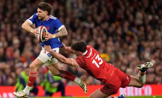 France's Matthieu Jalibert, left, in action during the Six Nations rugby union match between Wales and France in Cardiff, Wales, Sunday Feb. 15, 2026. (Andrew Matthews/PA via AP)