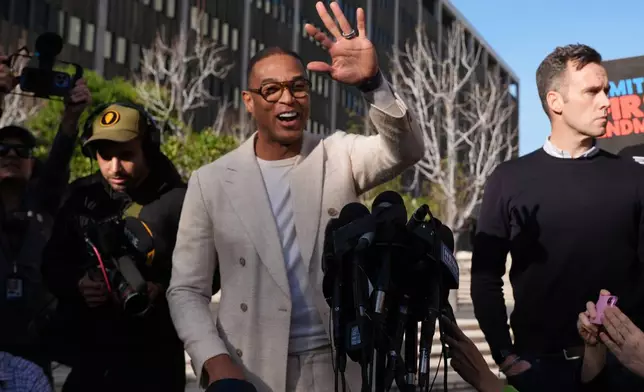 Journalist Don Lemon, waves to the media after a hearing outside the Edward R. Roybal Federal Building in Los Angeles on Friday, Jan. 30, 2026. (AP Photo/Damian Dovarganes)