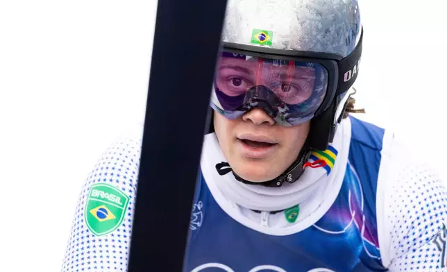 Brazil's Lucas Pinheiro Braathen checks his time at the finish area after the first run of an alpine ski, men's giant slalom race, at the 2026 Winter Olympics, in Bormio, Italy, Saturday, Feb. 14, 2026. (Michael Buholzer/Keystone via AP)