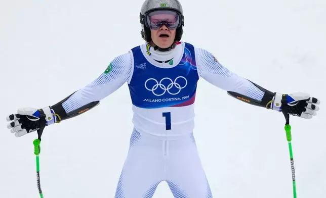 Brazil's Lucas Pinheiro Braathen celebrates winning an alpine ski, men's giant slalom race, at the 2026 Winter Olympics, in Bormio, Italy, Saturday, Feb. 14, 2026. (AP Photo/John Locher)