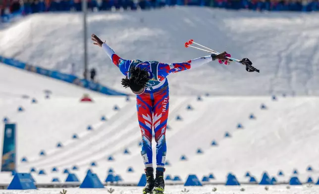 Stevenson Savart, of Haiti, bows as he crosses the finish line in the cross country skiing men's 10km + 10km skiathlon at the 2026 Winter Olympics, in Tesero, Italy, Sunday, Feb. 8, 2026. (AP Photo/Kirsty Wigglesworth)
