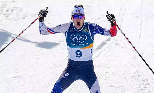 Mathis Desloges, of France, celebrates after winning the silver medal in the cross country skiing men's 10km + 10km skiathlon at the 2026 Winter Olympics, in Tesero, Italy, Sunday, Feb. 8, 2026. (AP Photo/Matthias Schrader)