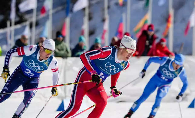Johannes Hoesflot Klaebo, of Norway, Gus Schumacher, of the United States, left, and Federico Pellegrino, of Italy, right, compete in the cross-country skiing men's team sprint free at the 2026 Winter Olympics, in Tesero, Italy, Wednesday, Feb. 18, 2026. (AP Photo/Evgeniy Maloletka)