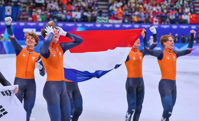 Team Netherlands celebrates after a short track speed skating men's 5000 meters relay final at the 2026 Winter Olympics, in Milan, Italy, Friday, Feb. 20, 2026. (AP Photo/Natacha Pisarenko)