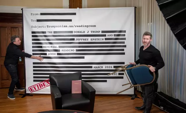 An "Epstein Reading Room" studio backdrop is set up at a rebuttal to President Donald Trump's State of the Union hosted by Defiance.org, the Portland Frog Brigade and COURIER at the National Press Club in Washington, Tuesday, Feb. 24, 2026. (AP Photo/Cliff Owen)