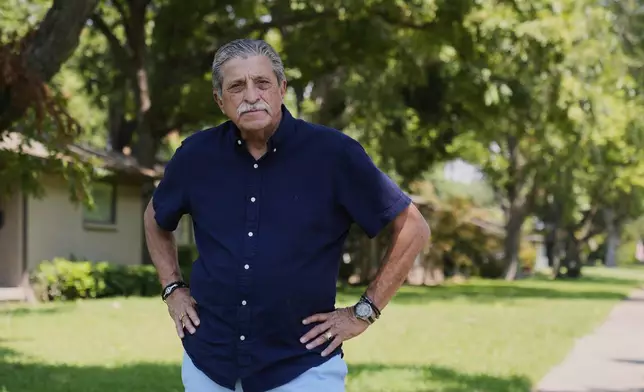Rene Martinez, president of Dallas LULAC #100, poses for a photo in front of his home Monday, Aug. 25, 2025, in Dallas. (AP Photo/Tony Gutierrez)