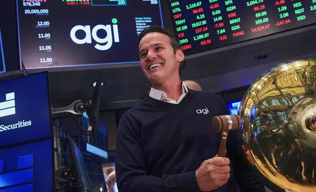 AGI Inc Founder, Executive Chairman &amp; CEO Marciano Testa rings a ceremonial bell on the floor of the New York Stock Exchange as his company's IPO begins trading, Wednesday, Feb. 11, 2026. (AP Photo/Richard Drew)