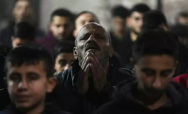 Muslim worshippers perform evening Tarawih prayer on the first night of the holy fasting month of Ramadan at the Great Omari Mosque, which was damaged during the Israel–Hamas war, in Gaza City, Tuesday, Feb. 17, 2026. (AP Photo/Abdel Kareem Hana)