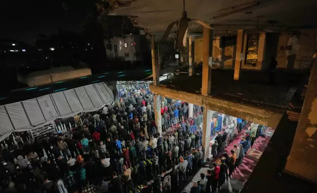 Muslim worshippers perform evening Tarawih prayer on the first night of the holy fasting month of Ramadan at the Alkanz Mosque, which was damaged during the Israel–Hamas war, in Gaza City, Tuesday, Feb. 17, 2026. (AP Photo/Jehad Alshrafi)
