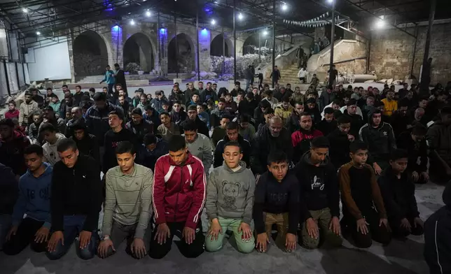 Muslim worshippers perform evening Tarawih prayer on the first night of the holy fasting month of Ramadan at the Great Omari Mosque, which was damaged during the Israel–Hamas war, in Gaza City, Tuesday, Feb. 17, 2026. (AP Photo/Abdel Kareem Hana)