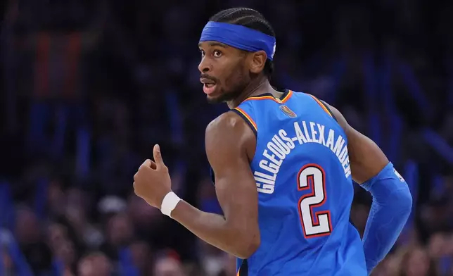 Oklahoma City Thunder guard Shai Gilgeous-Alexander looks back after making a basket during the second half of an NBA basketball game against the Orlando Magic, Tuesday, Feb. 3, 2026, in Oklahoma City. (AP Photo/Nate Billings)