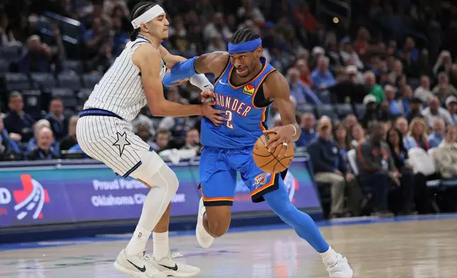 Oklahoma City Thunder guard Shai Gilgeous-Alexander (2) drives against Orlando Magic guard Anthony Black, left, during the second half of an NBA basketball game Tuesday, Feb. 3, 2026, in Oklahoma City. (AP Photo/Nate Billings)