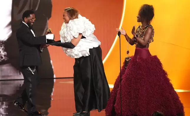 Kendrick Lamar, left, accepts the award for best rap album for "GNX" from Queen Latifah, and Doechii during the 68th annual Grammy Awards on Sunday, Feb. 1, 2026, in Los Angeles. (AP Photo/Chris Pizzello)