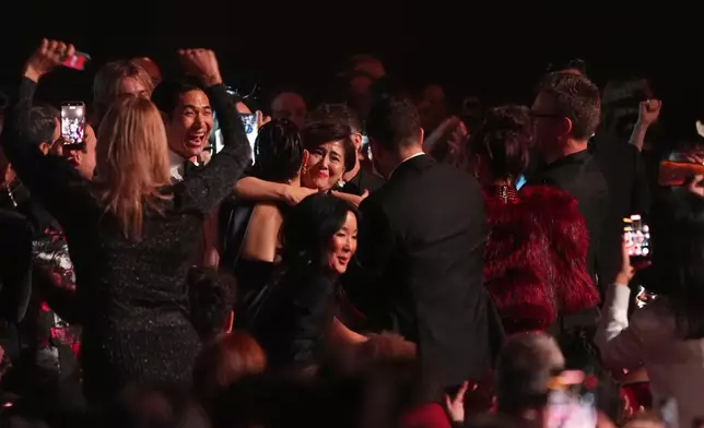 The team from KPop Demon Hunters react in the audience to winning the award for best song written for visual media for "Golden" during the 68th annual Grammy Awards on Sunday, Feb. 1, 2026, in Los Angeles. (AP Photo/Chris Pizzello)