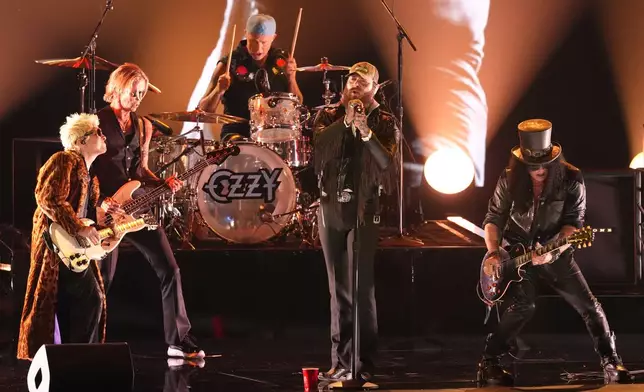 Andrew Watt, from left, Duff McKagan, Chad Smith, Post Malone and Slash perrform "War Pigs" during the in memoriam tribute for the 68th annual Grammy Awards on Sunday, Feb. 1, 2026, in Los Angeles. (AP Photo/Chris Pizzello)