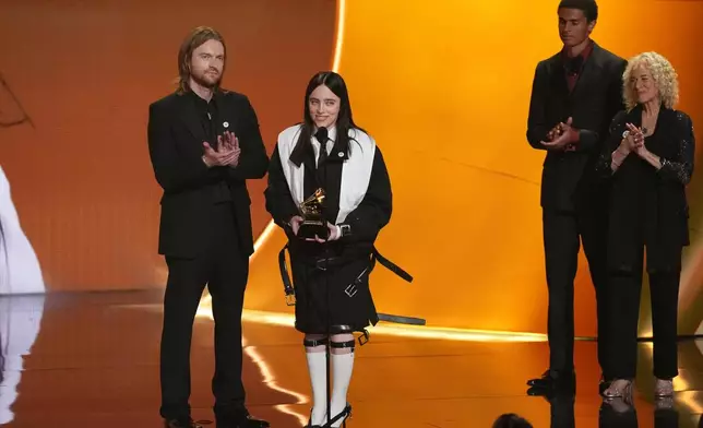Finneas, left, and Billie Eilish accept the award for song of the year for "Wildflower" during the 68th annual Grammy Awards on Sunday, Feb. 1, 2026, in Los Angeles. Carole King looks on from right. (AP Photo/Chris Pizzello)