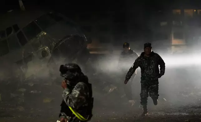 Military police on the scene where a plane crashed in El Alto, Bolivia, Friday, Feb. 27, 2026. (AP Photo/Juan Karita)