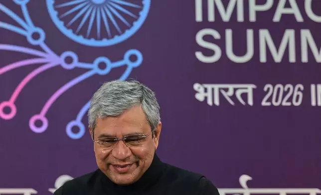 Indian Technology Minister Ashwini Vaishnaw greets media at a press conference during AI Impact Summit in New Delhi, India, Tuesday, Feb.17, 2026. (AP Photo)