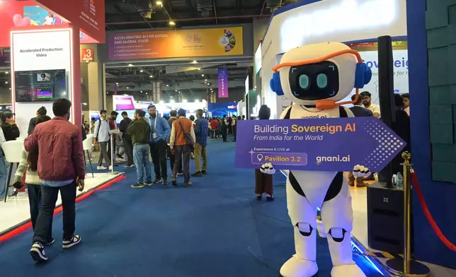 Delegates watch an exhibition in the sidelines of an AI Impact Summit in New Delhi, India, Tuesday, Feb.17, 2026. (AP Photo)