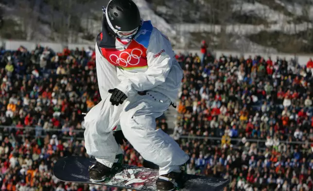 FILE - United States' Shaun White sails high above the crowd in his first run to take the gold medal for the Men's Halfpipe Snowboard competition at the Turin 2006 Winter Olympic Games in Bardonecchia, Italy Sunday, Feb. 12, 2006. (AP Photo/Peter Dejong, File)