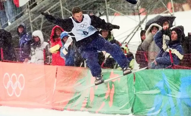 FILE - Gian Simmen of Switzerland loses his hat during a maneuver on his way to winning the gold medal in the men's halfpipe competition Thursday, Feb. 12, 1998, in Yamanouchi, Japan. (AP Photo/Robert F. Bukaty, FIle)
