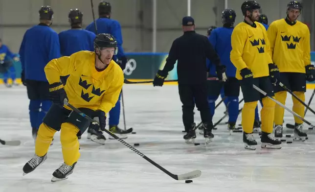 Sweden's Gabriel Landeskog skates with the puck during men's ice hockey practice at the 2026 Winter Olympics, in Milan, Italy, Sunday, Feb. 8, 2026. (AP Photo/Carolyn Kaster)