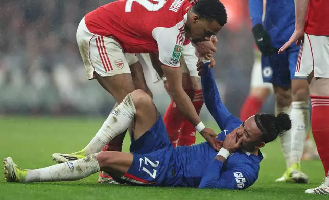 Chelsea's Malo Gusto reacts after sustaining an injury during the English League Cup semifinal second leg soccer match between Arsenal and Chelsea in London, Tuesday, Feb. 3, 2026. (AP Photo/Ian Walton)
