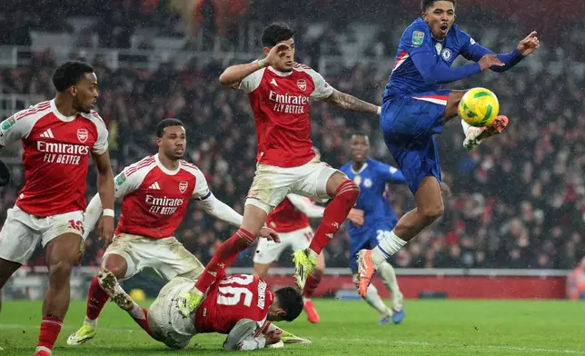 Chelsea's Wesley Fofana, right, kicks the ball during the English League Cup semifinal second leg soccer match between Arsenal and Chelsea in London, Tuesday, Feb. 3, 2026. (AP Photo/Ian Walton)