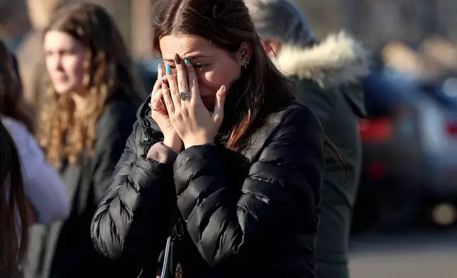 A woman reacts near the Lynch Arena in Pawtucket, R.I., after a shooting at the ice rink, Monday, Feb. 16, 2026. (AP Photo/Mark Stockwell)